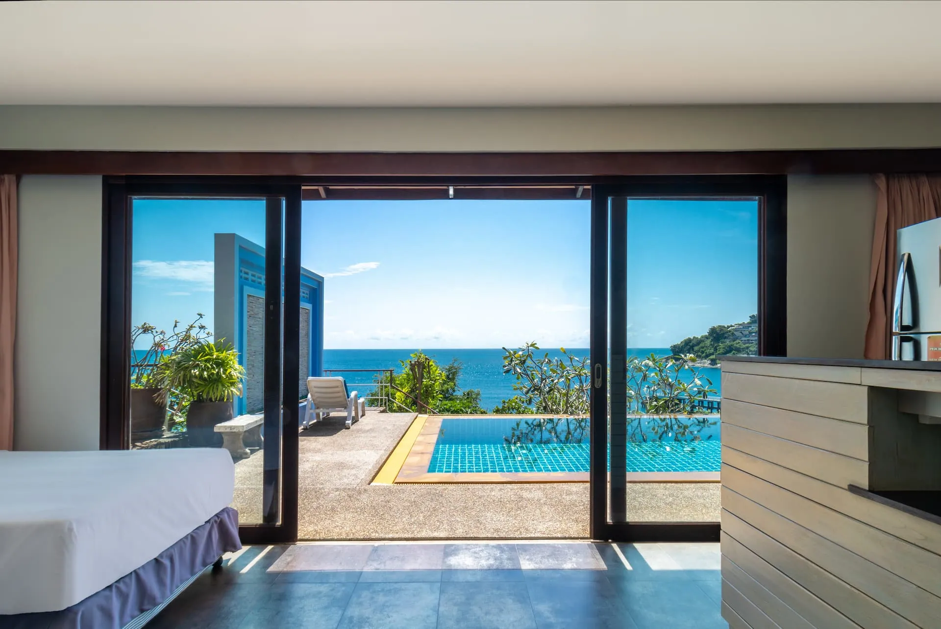 Bedroom with sliding glass doors that open straight onto the pool terrace