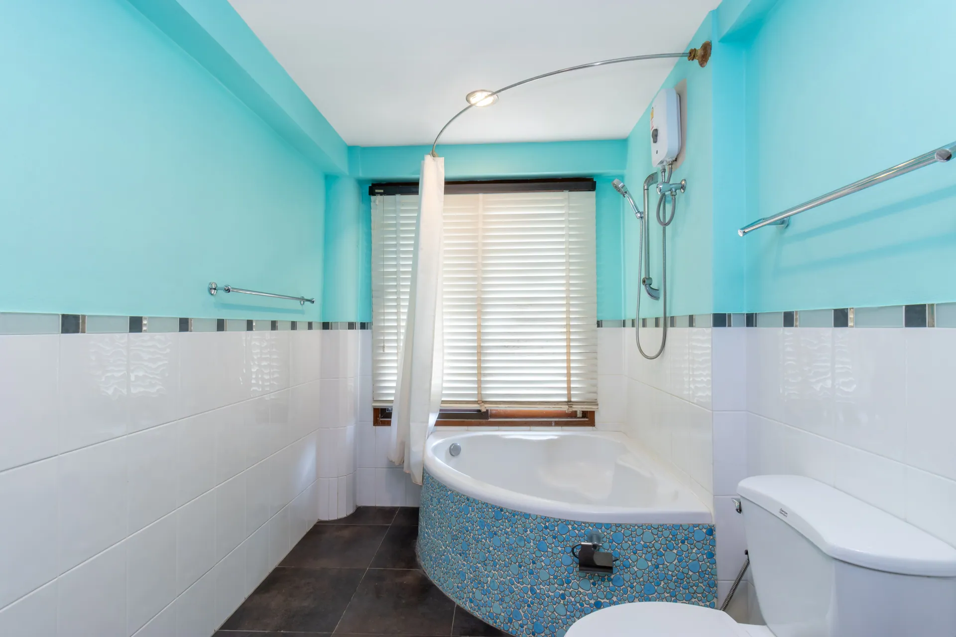Bathroom with a corner bathtub and a shower