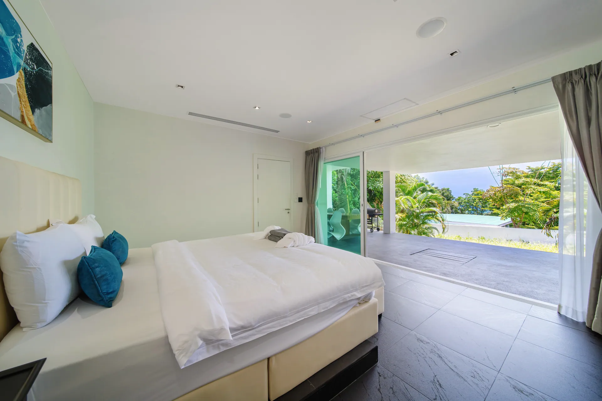 Bedroom with sliding glass doors opening onto a covered garden terrace