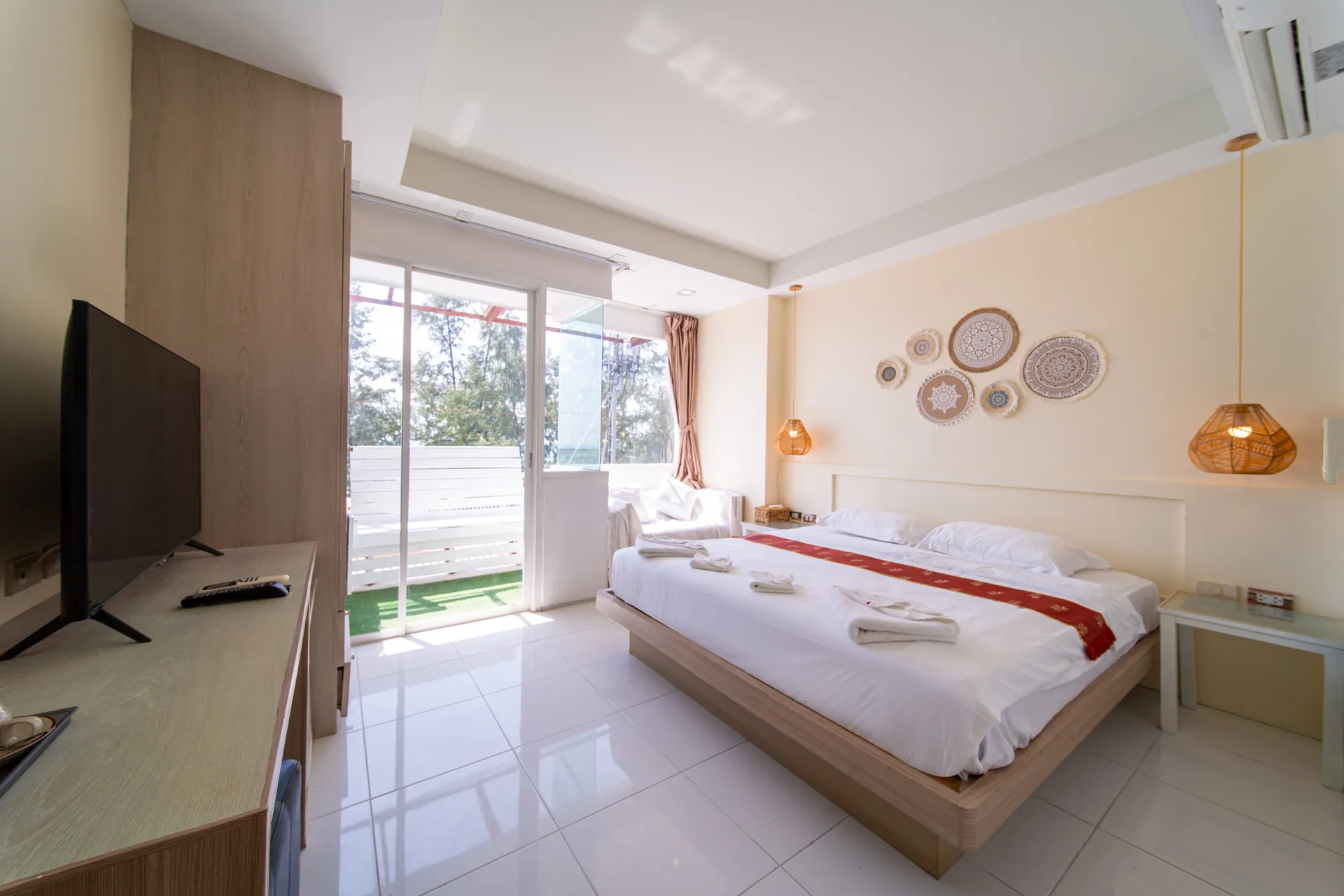 Sea View King Room with a king bed and a glass door to the balcony