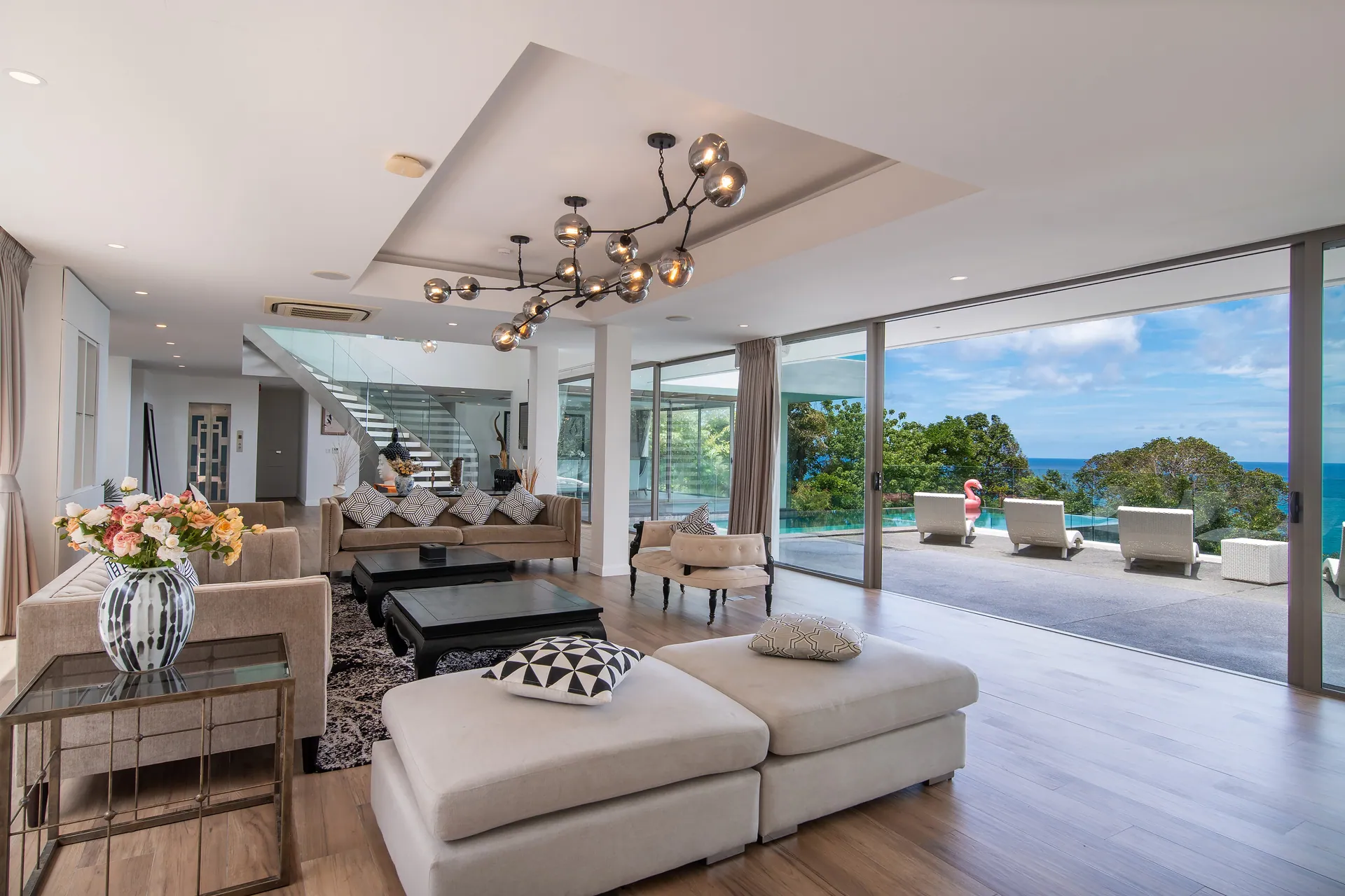 Open-plan living room with sofas and sliding glass doors onto the terrace