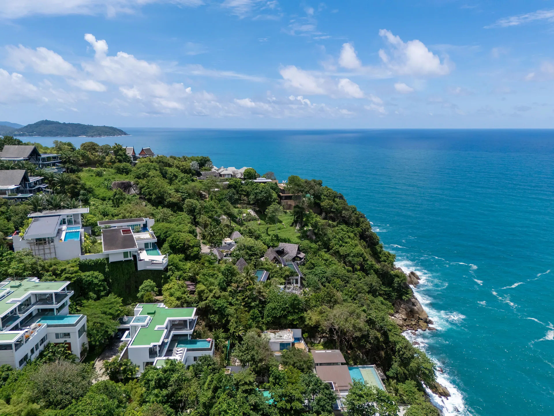Aerial view of the wooded headland and coastline around the villa