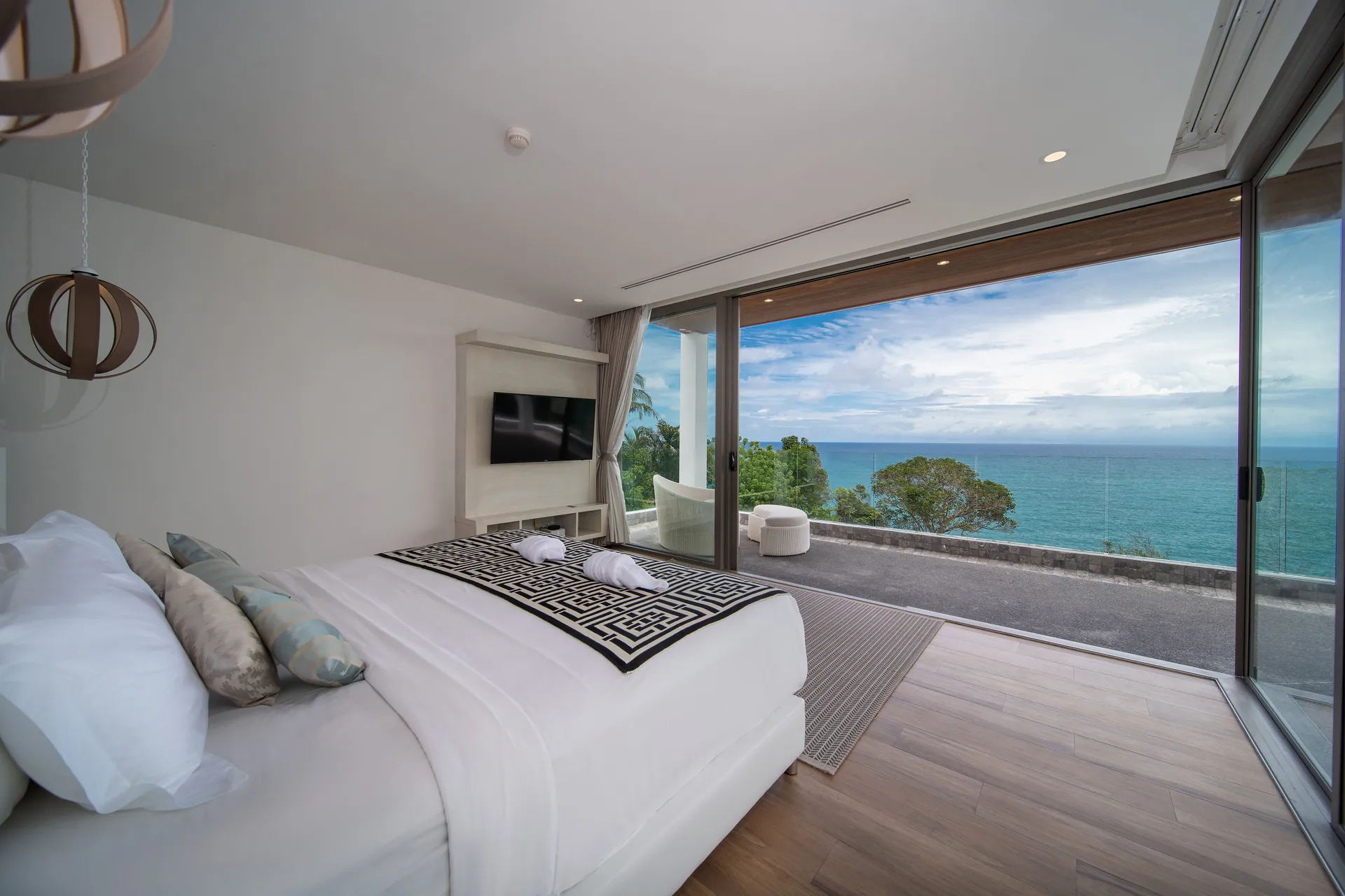 Master suite with a king bed and sliding doors to a sea-view balcony