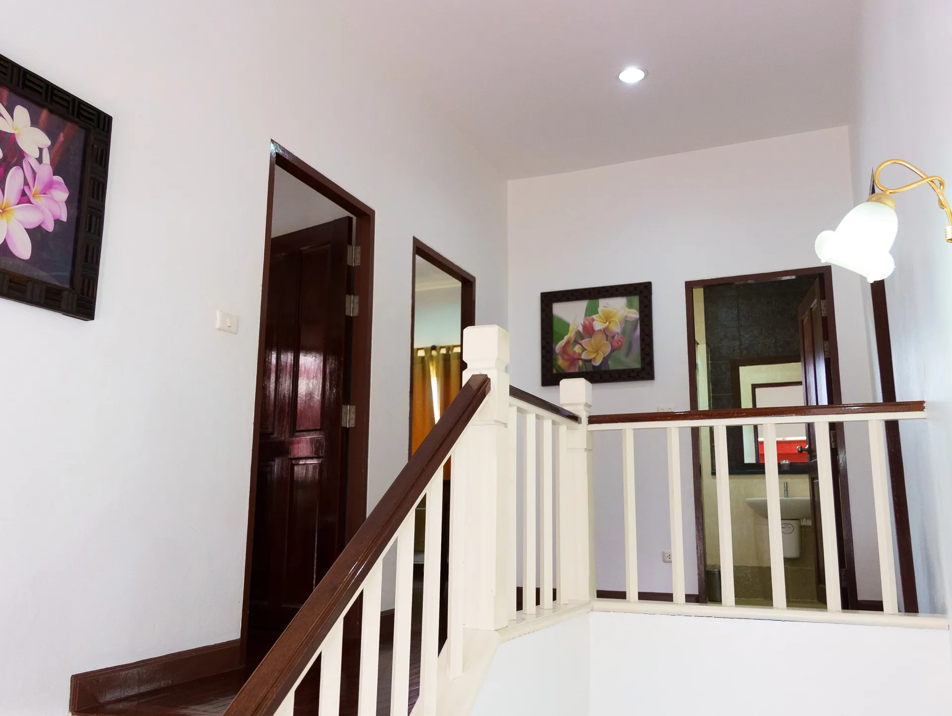Upstairs landing with a timber handrail and doors leading to the bedrooms
