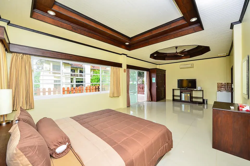 Bedroom with a king bed and a window facing the balcony railing