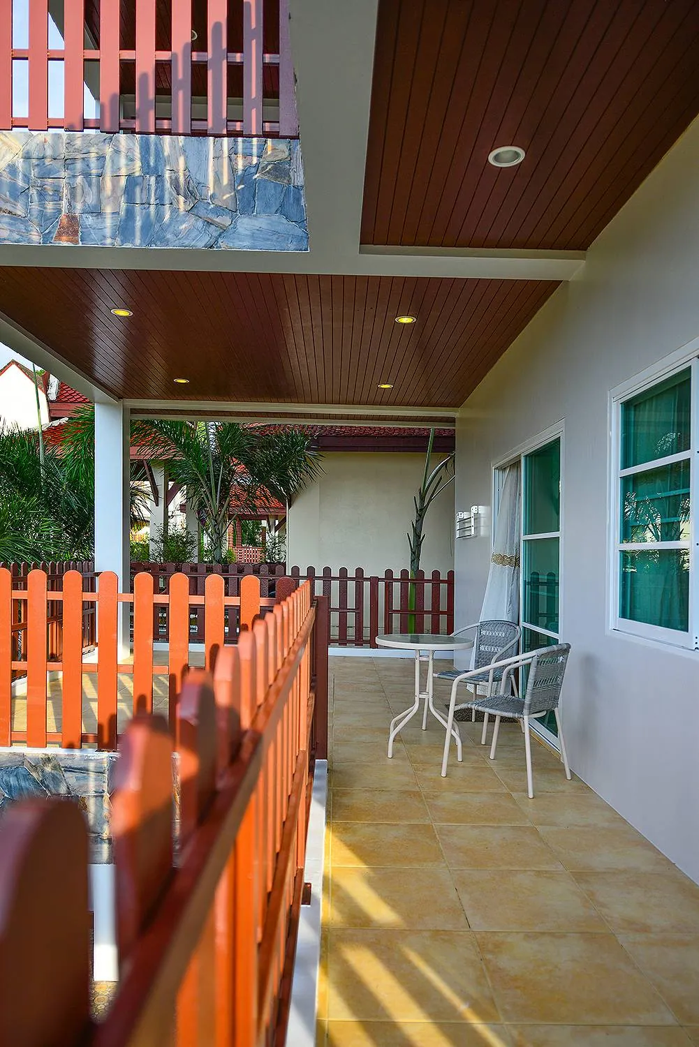 Upper-floor balcony with a timber railing and an outdoor table