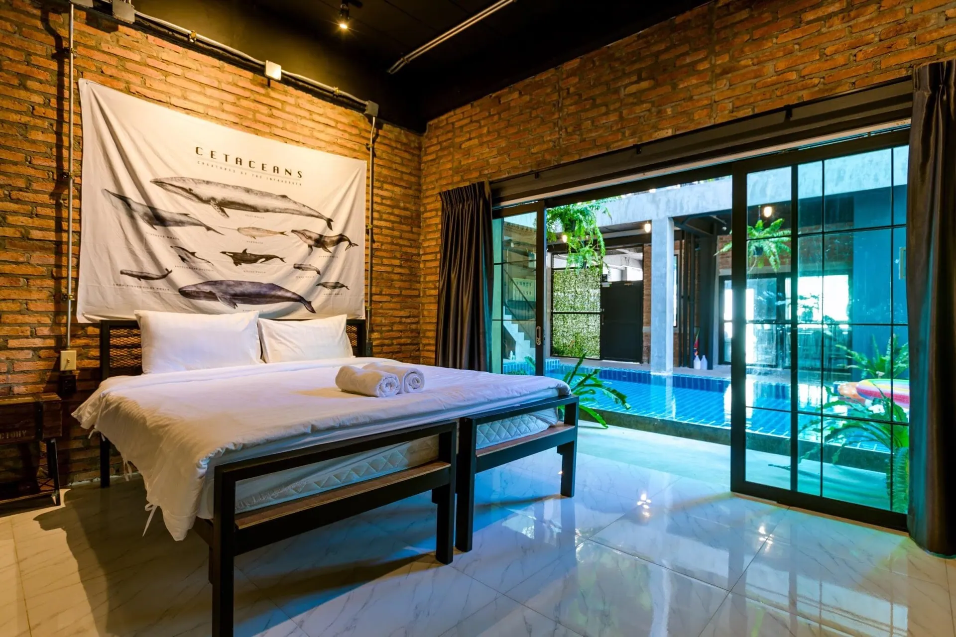 King bedroom with sliding glass doors opening onto the pool