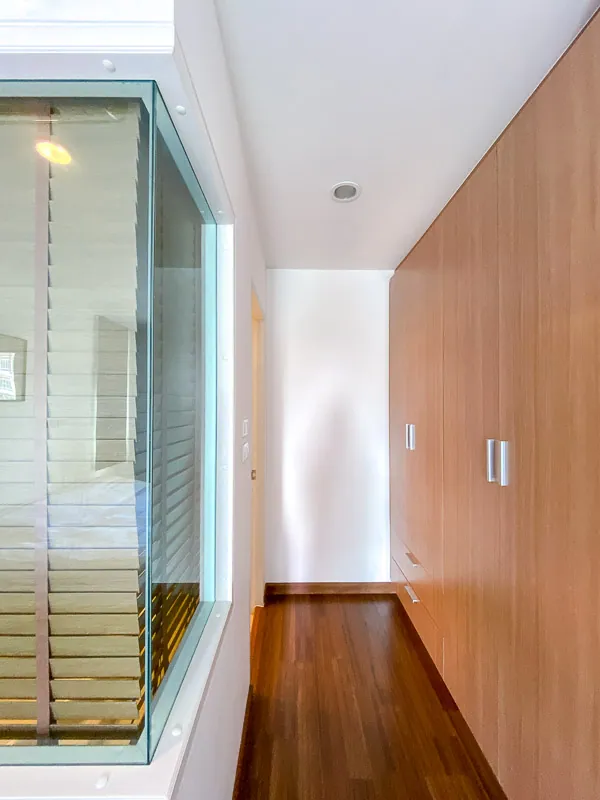 Hallway with built-in timber wardrobes and a glazed partition to the bedroom