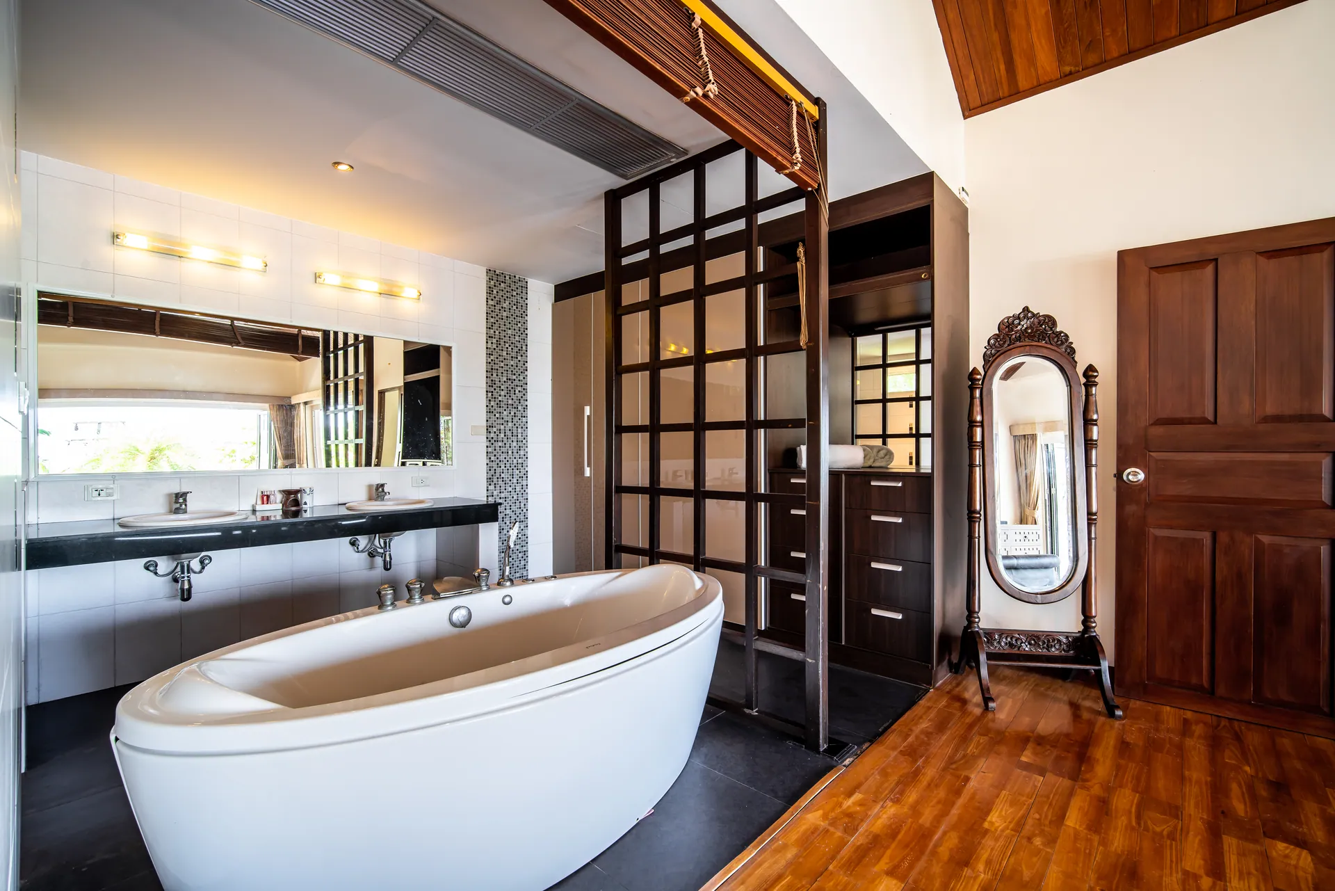 Bedroom 1 bathroom with a freestanding oval bath, a double vanity and a timber lattice screen