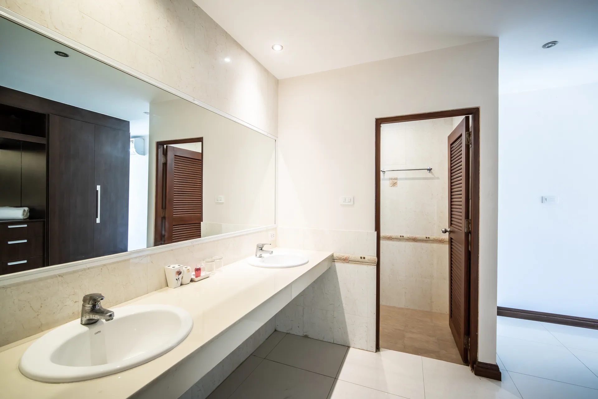 Lower-floor bathroom with a marble-effect vanity and a separate shower room