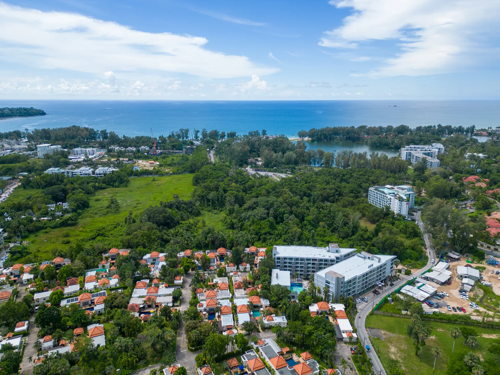 Aerial view over the surrounding neighbourhood, with lagoons and the sea beyond