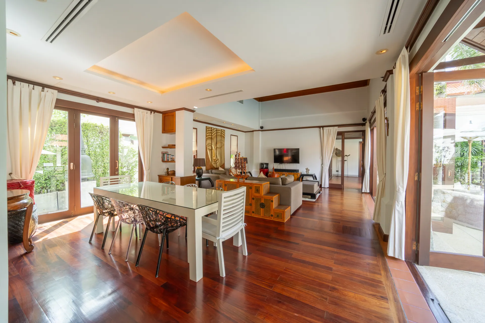 Dining table beside glass doors to the garden, with the living room beyond