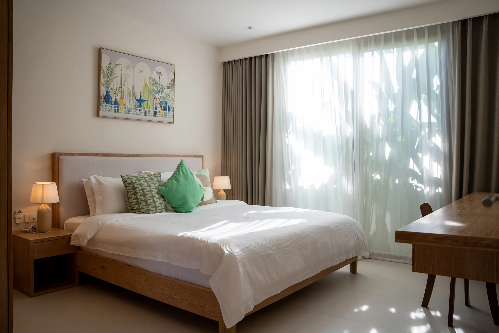 Second bedroom with a double bed, a writing desk and sheer curtains over a garden window