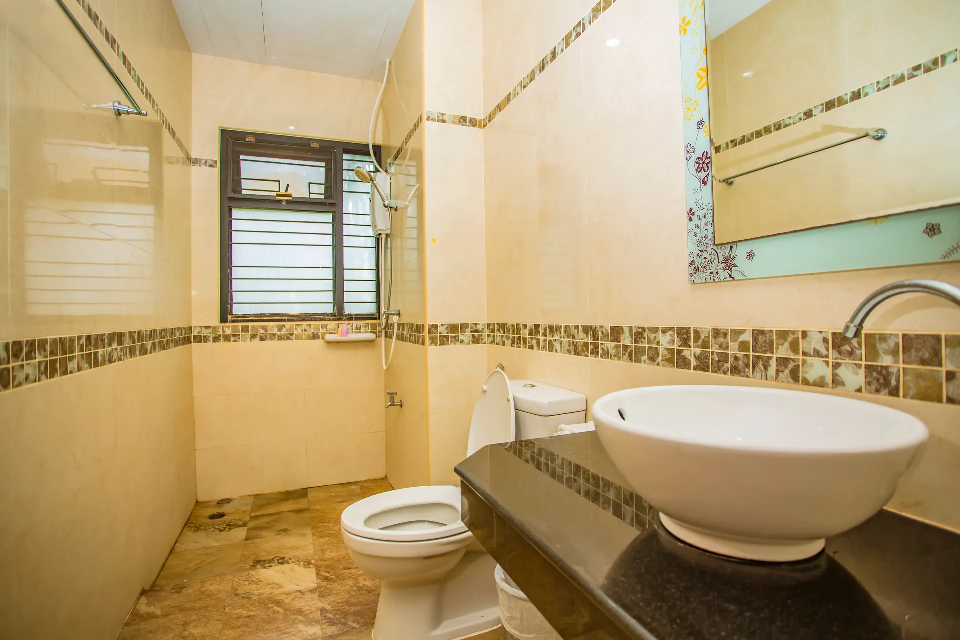 Cream-tiled bathroom with a walk-in shower and a vessel basin