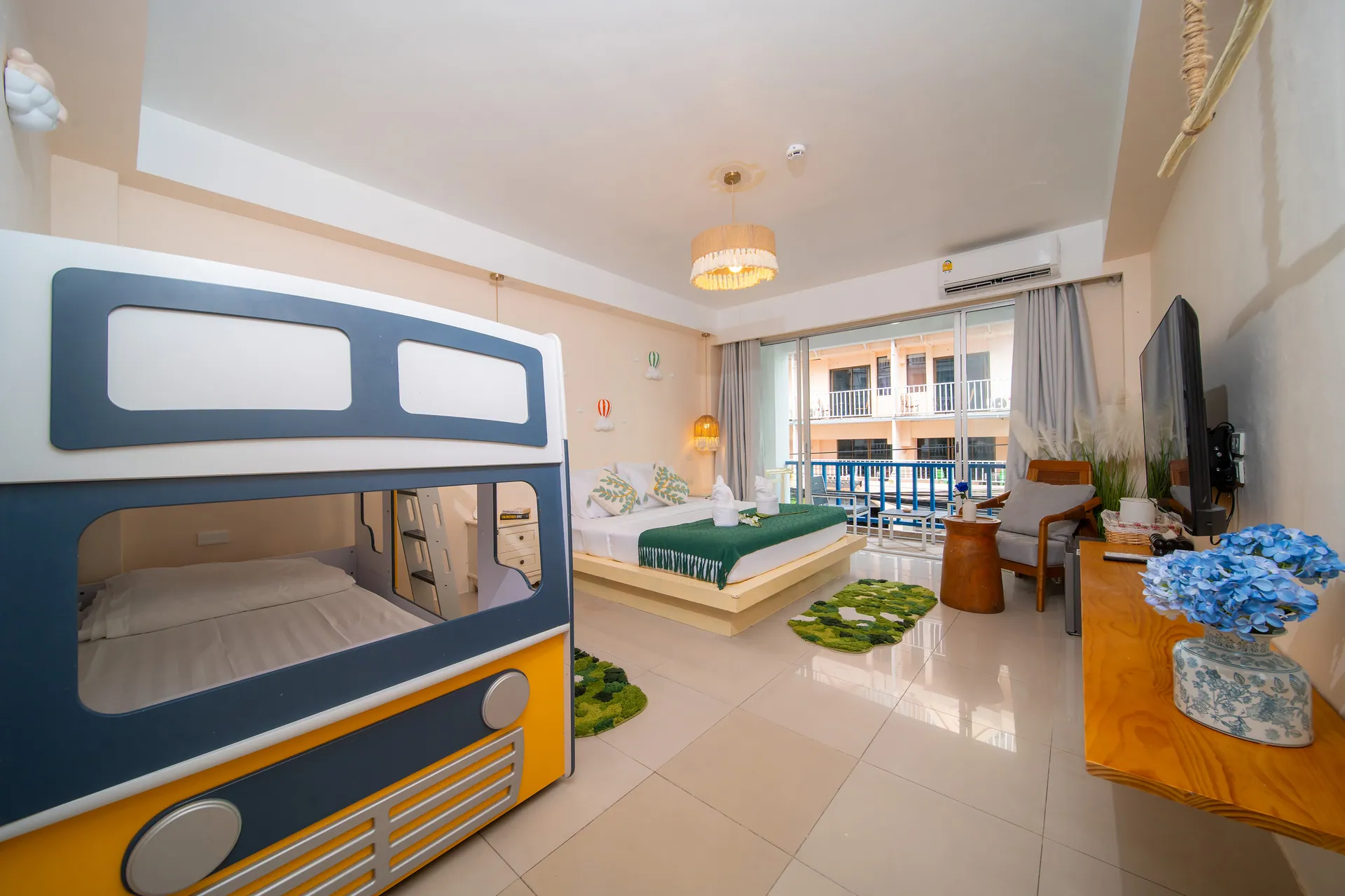 Family Room with a bus-shaped bunk bed, a double bed and a balcony door