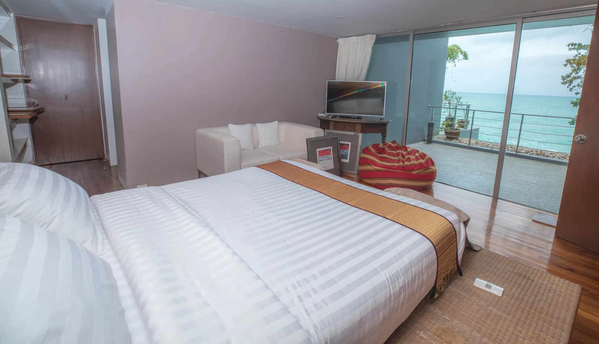 Bedroom with sliding glass doors to a balcony overlooking the sea