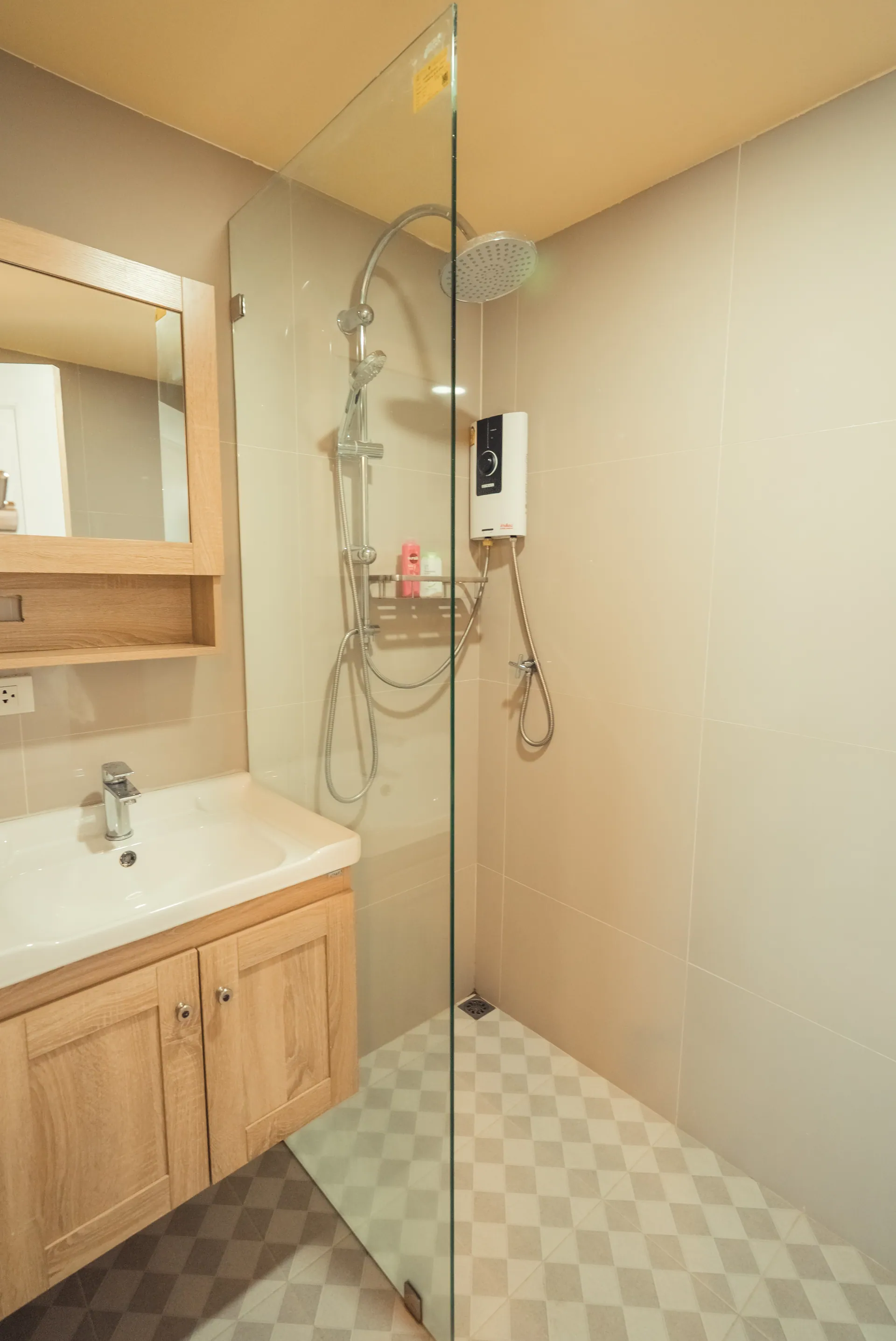 Bathroom with a glass-screened walk-in shower, a timber vanity and a mirrored cabinet
